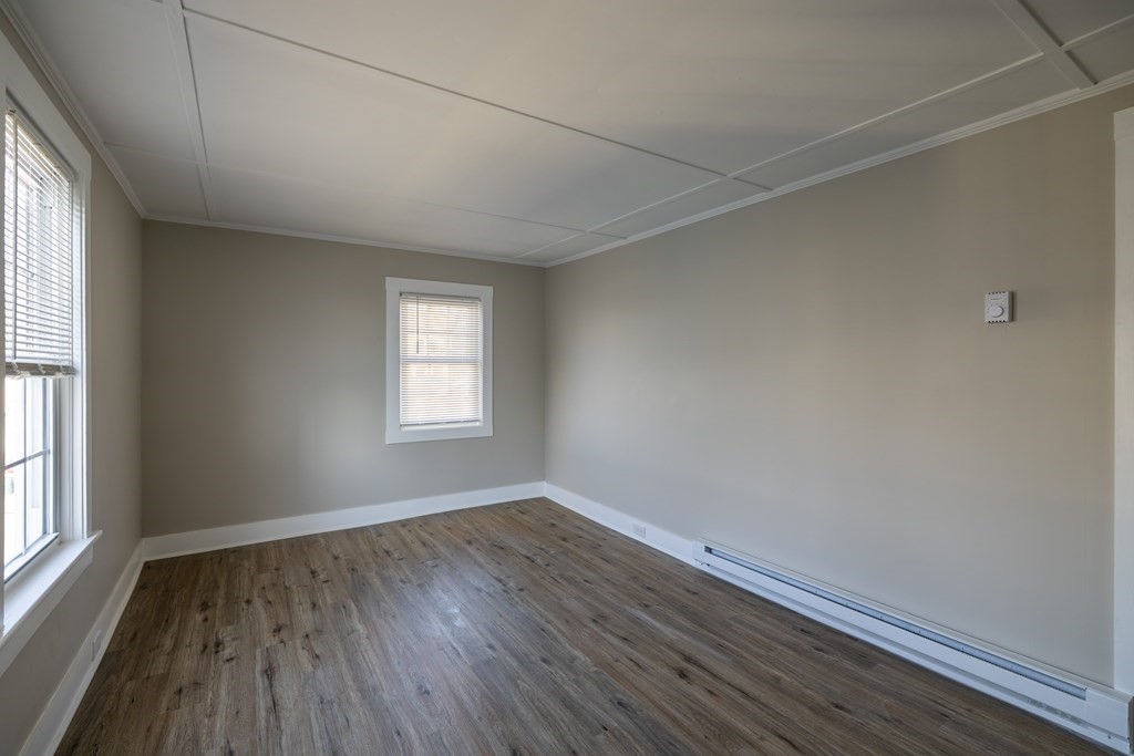 268 Locust Street Fall River, MA 02720 - Photo 32 of 38 an empty room with wooden floor and windows