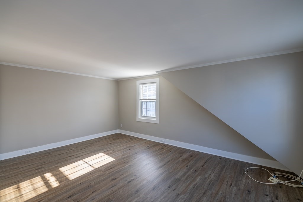 268 Locust Street Fall River, MA 02720 - Photo 34 of 38 a view of empty room with wooden floor and fan