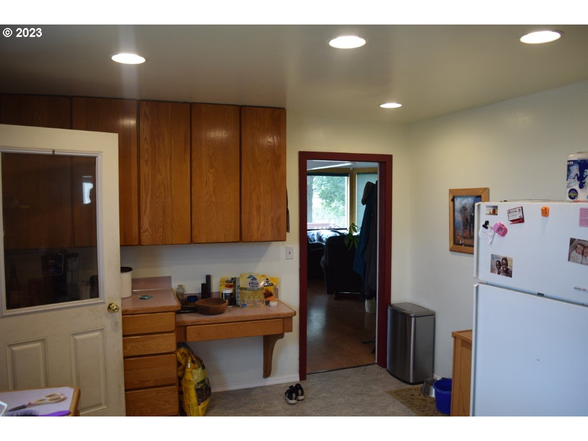 327 West Main Street Athena, OR 97813 - Photo 11 of 48 a kitchen with refrigerator and cabinets