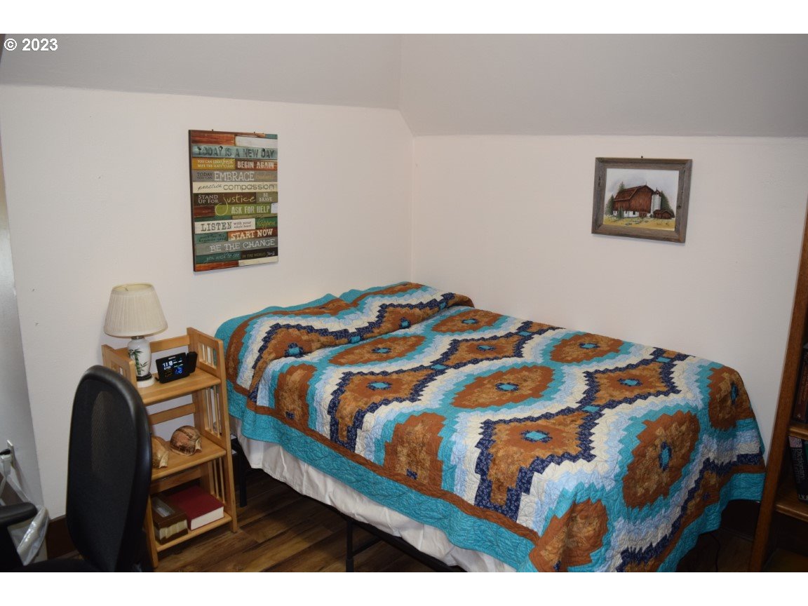 327 West Main Street Athena, OR 97813 - Photo 21 of 48 a bedroom with a bed and a painting on the wall