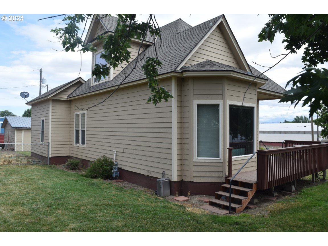 327 West Main Street Athena, OR 97813 - Photo 5 of 48 a view of a house with a yard plants and large tree