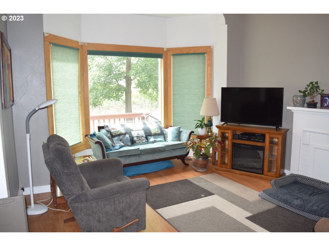 327 West Main Street Athena, OR 97813 - Photo 6 of 48 a living room with furniture a flat screen tv and a fireplace