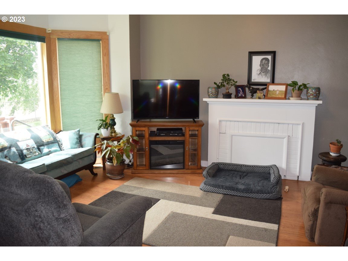 327 West Main Street Athena, OR 97813 - Photo 7 of 48 a living room with furniture a flat screen tv and a fireplace