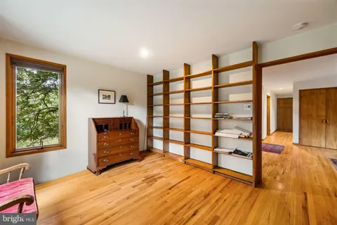 a view of a bedroom with furniture and window
