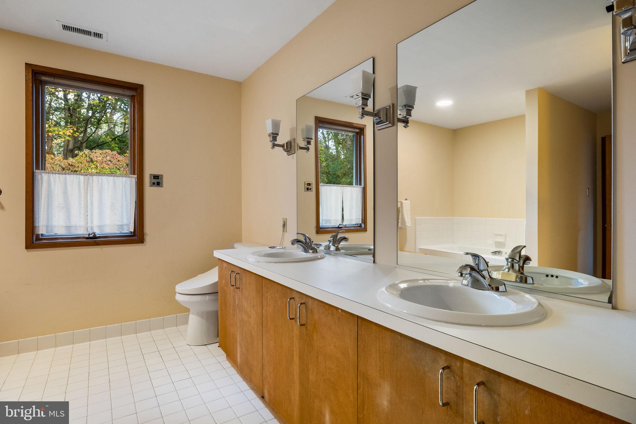 640 Harts Ridge Road Conshohocken, PA 19428 - Photo 25 of 46 a bathroom with a sink double vanity and a mirror