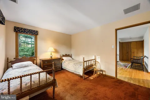 a bedroom with furniture and a window