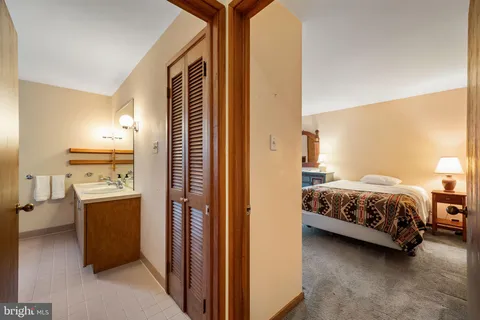 a view of a bedroom with a bed and a window