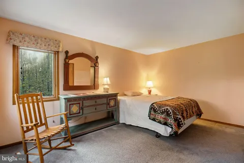 a room with a bed and a dresser