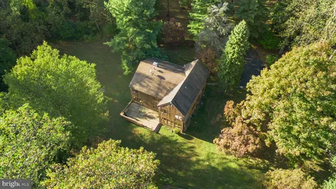 an aerial view of a house with a yard and lake view