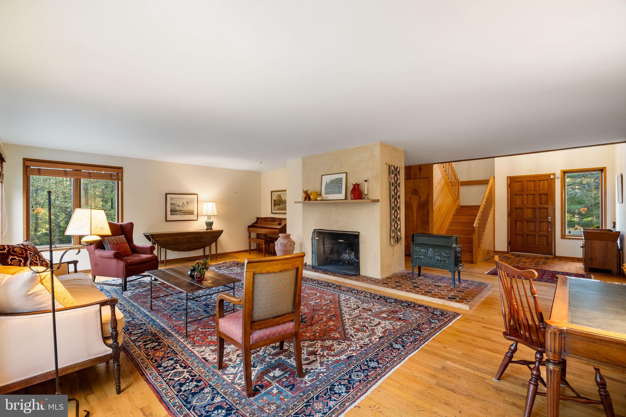 640 Harts Ridge Road Conshohocken, PA 19428 - Photo 7 of 46 a living room with furniture a fireplace and large windows