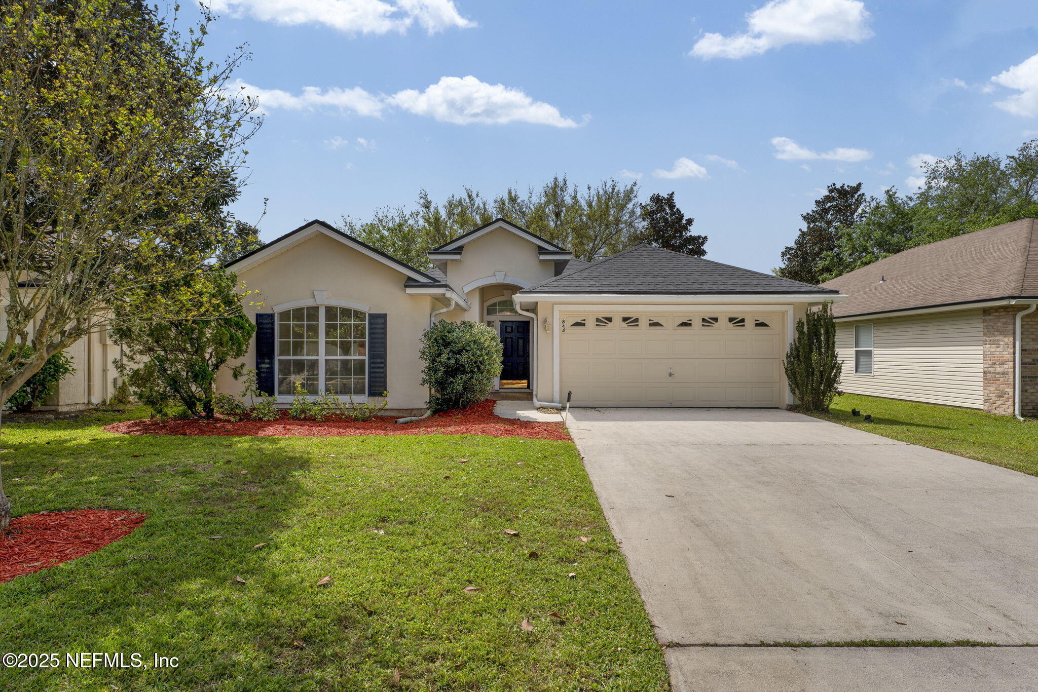 a view of a house with a yard and garage