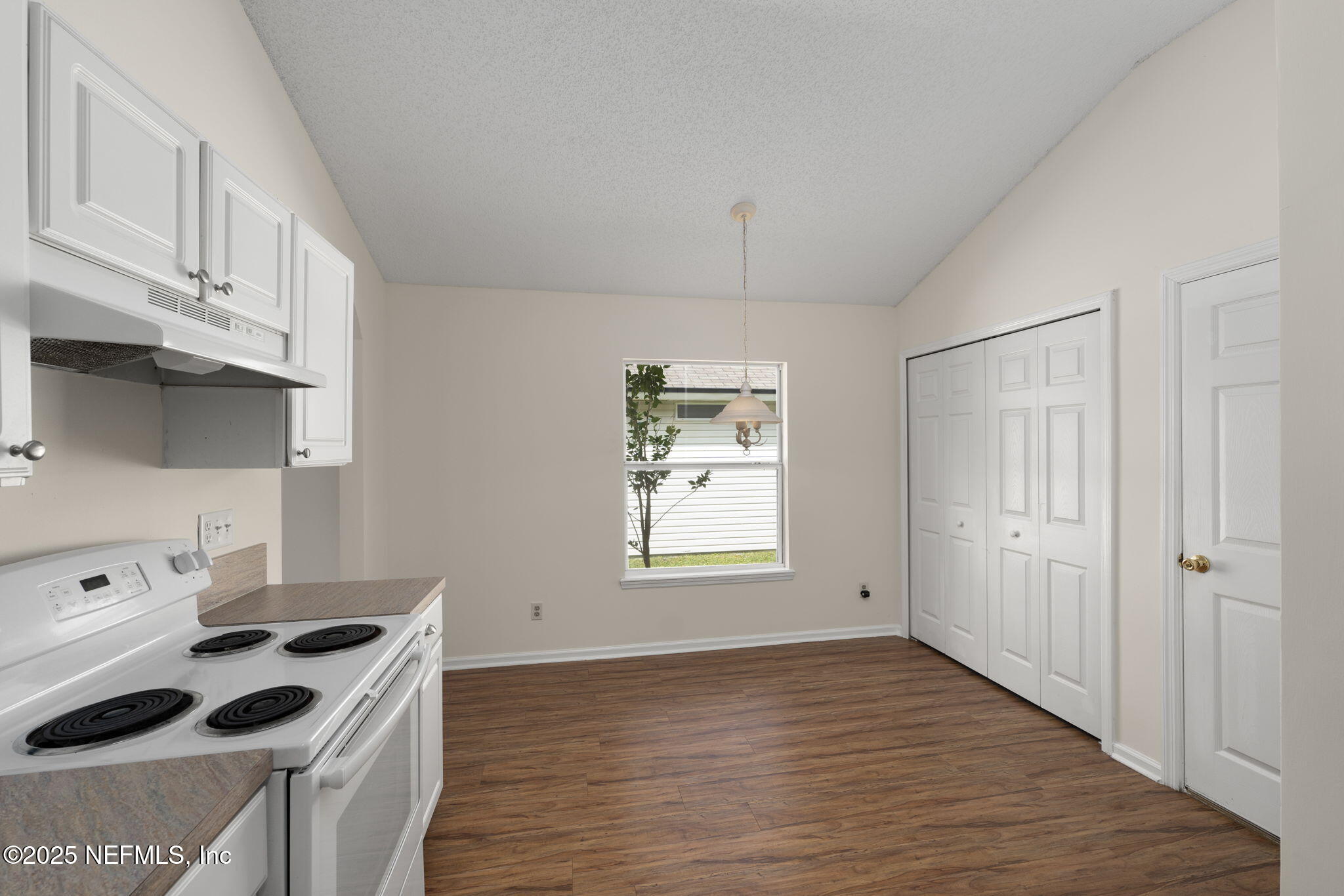 844 MacKenzie Circle St. Augustine, FL 32092 - Photo 11 of 40 a kitchen with a stove and white cabinets