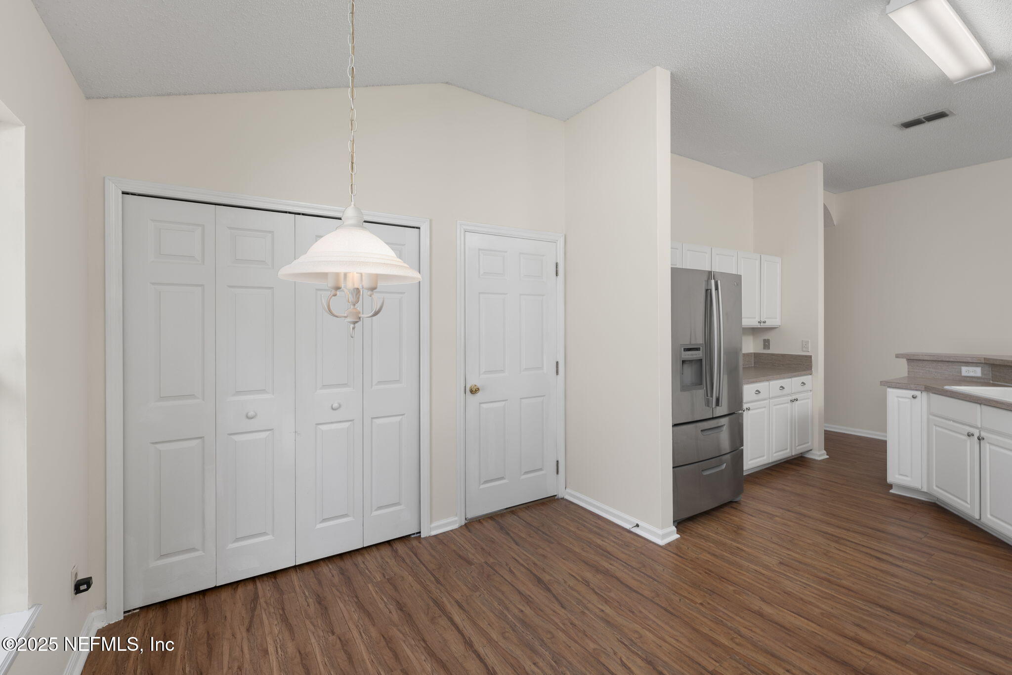 844 MacKenzie Circle St. Augustine, FL 32092 - Photo 12 of 40 a view of a kitchen with refrigerator and wooden floor