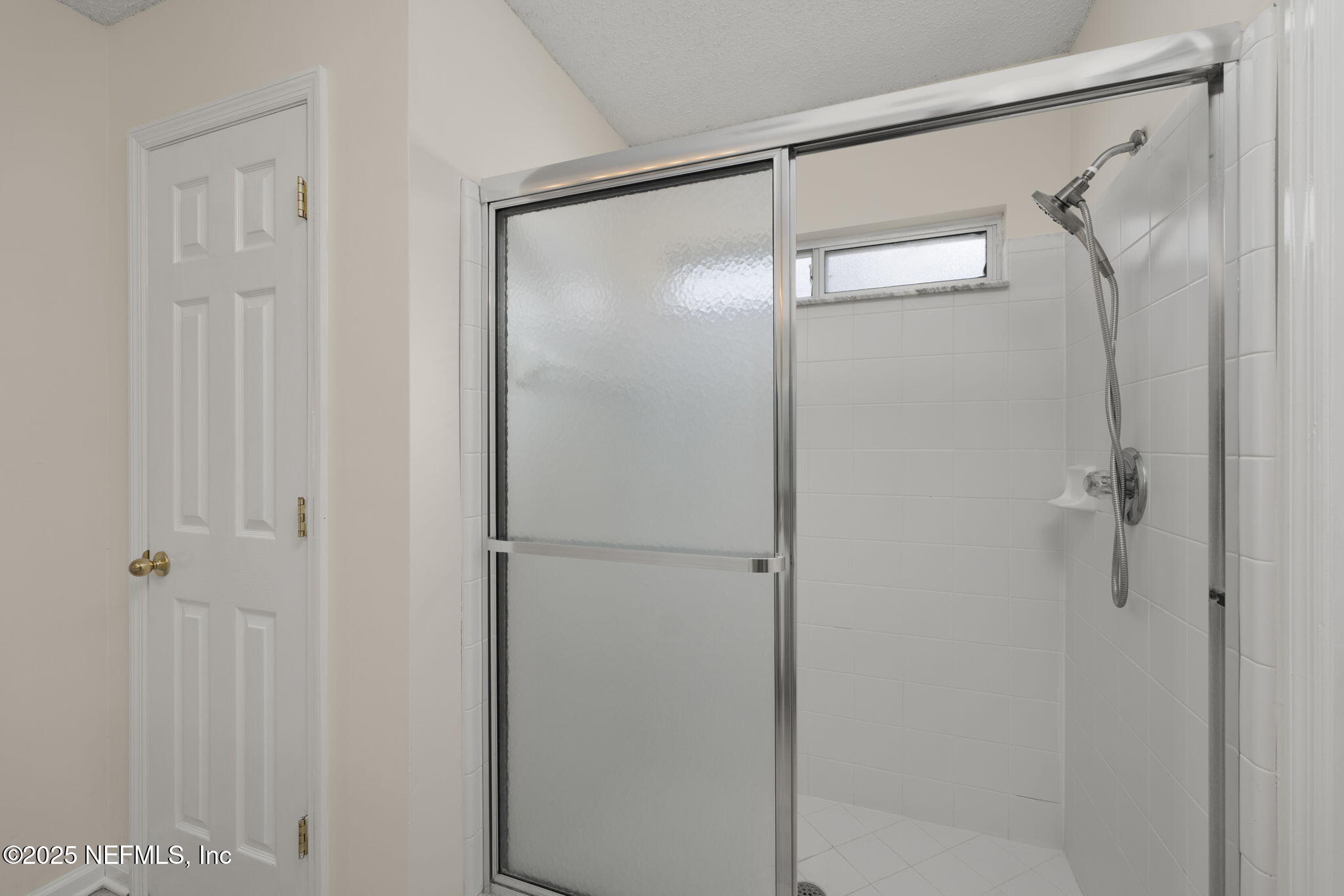 844 MacKenzie Circle St. Augustine, FL 32092 - Photo 20 of 40 a bathroom with a glass shower door
