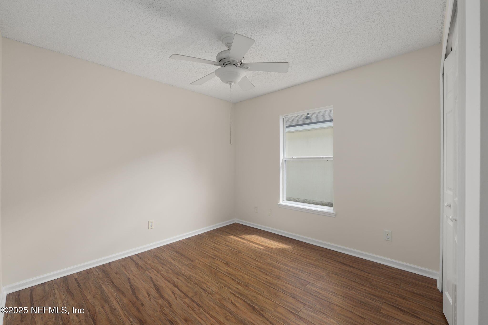 844 MacKenzie Circle St. Augustine, FL 32092 - Photo 23 of 40 an empty room with wooden floor fan and windows