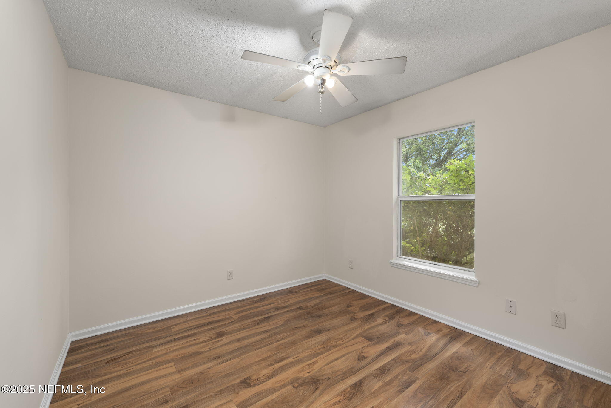 844 MacKenzie Circle St. Augustine, FL 32092 - Photo 26 of 40 an empty room with wooden floor and windows