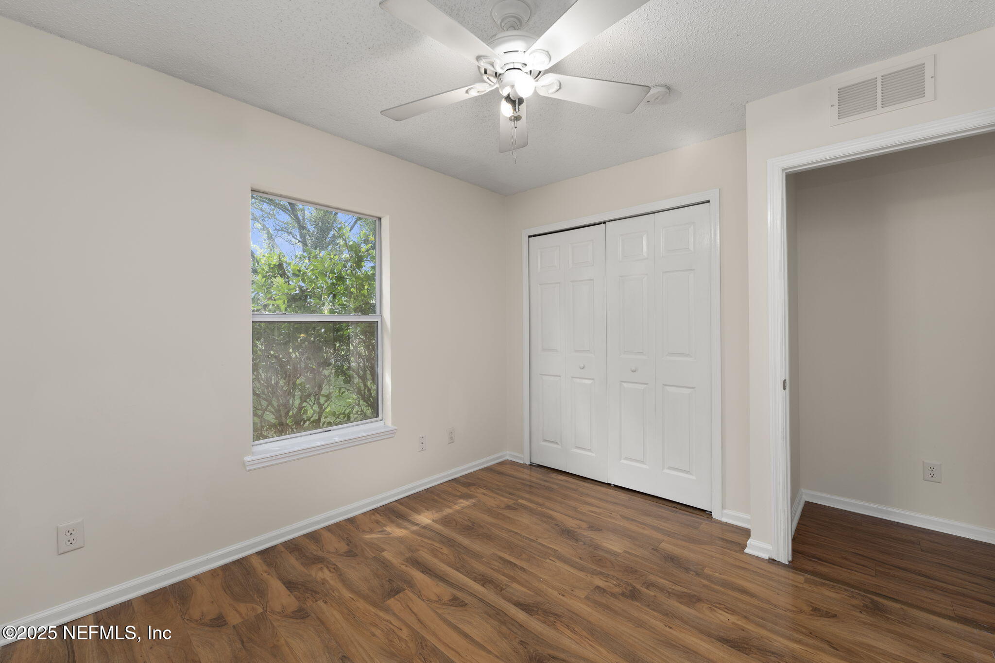 844 MacKenzie Circle St. Augustine, FL 32092 - Photo 27 of 40 wooden floor in an empty room with a window