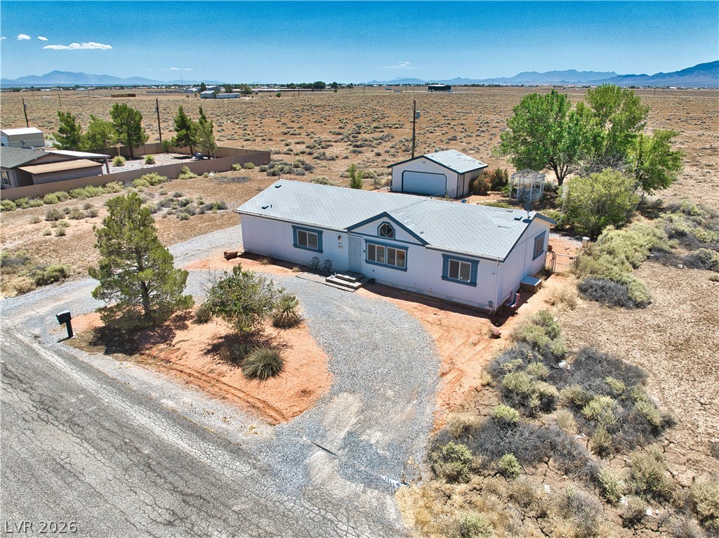 2931 Rio Rancho Drive, Unit 4 Pahrump, NV 89048 - Photo 17 of 21 A spacious desert residence awaits, complete with a detached garage and natural landscaping.