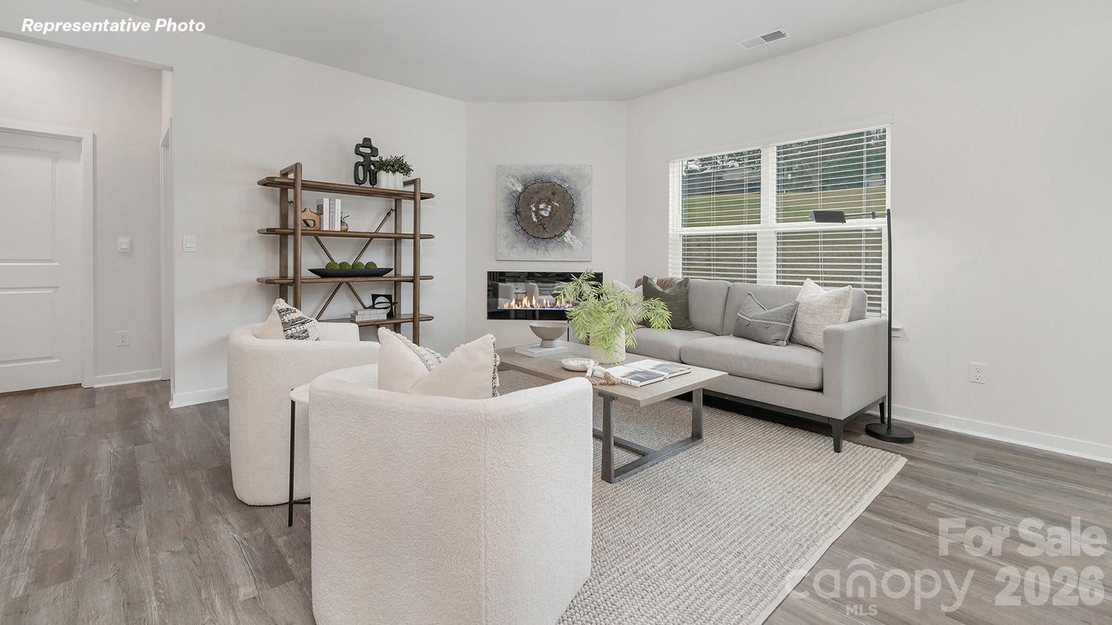 239 Superstar Street Salisbury, NC 28147 - Photo 6 of 28 a living room with furniture wooden floor and a large window