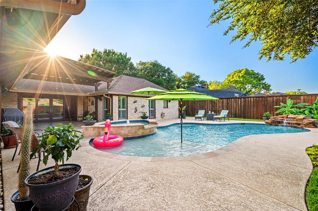 400 Hunters Ridge Circle Coppell, TX 75019 - Photo 2 of 35 a view of a backyard with table and chairs potted plants