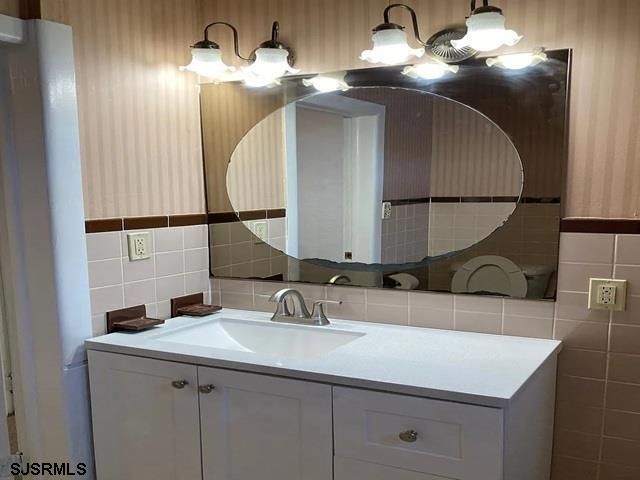 432 Wisteria Road Atlantic City, NJ 08401 - Photo 12 of 22 a bathroom with a sink and a mirror