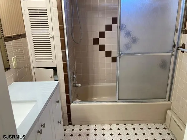 a bathroom with a bathtub and shower