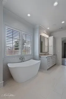 a spacious bathroom with a large tub and sink