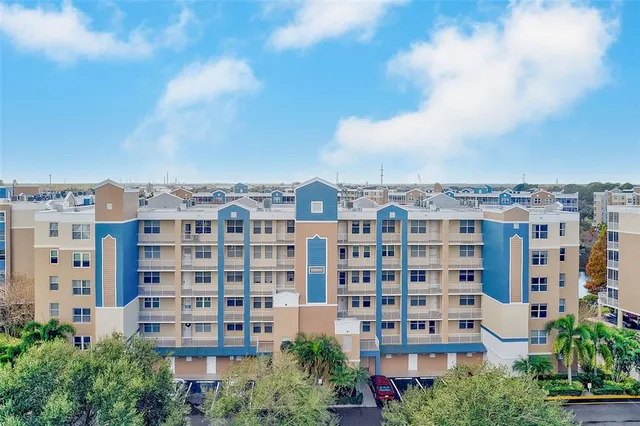 a view of a building with a lot of plants and trees