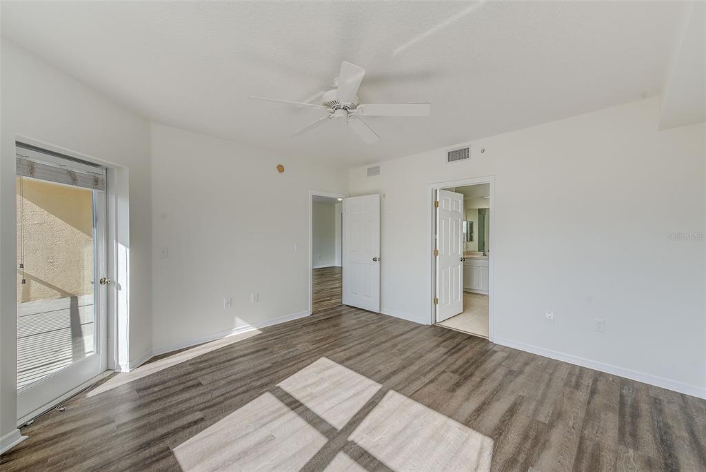 960 Starkey Road, Unit 3302 Largo, FL 33771 - Photo 11 of 28 wooden floor in an empty room with a window