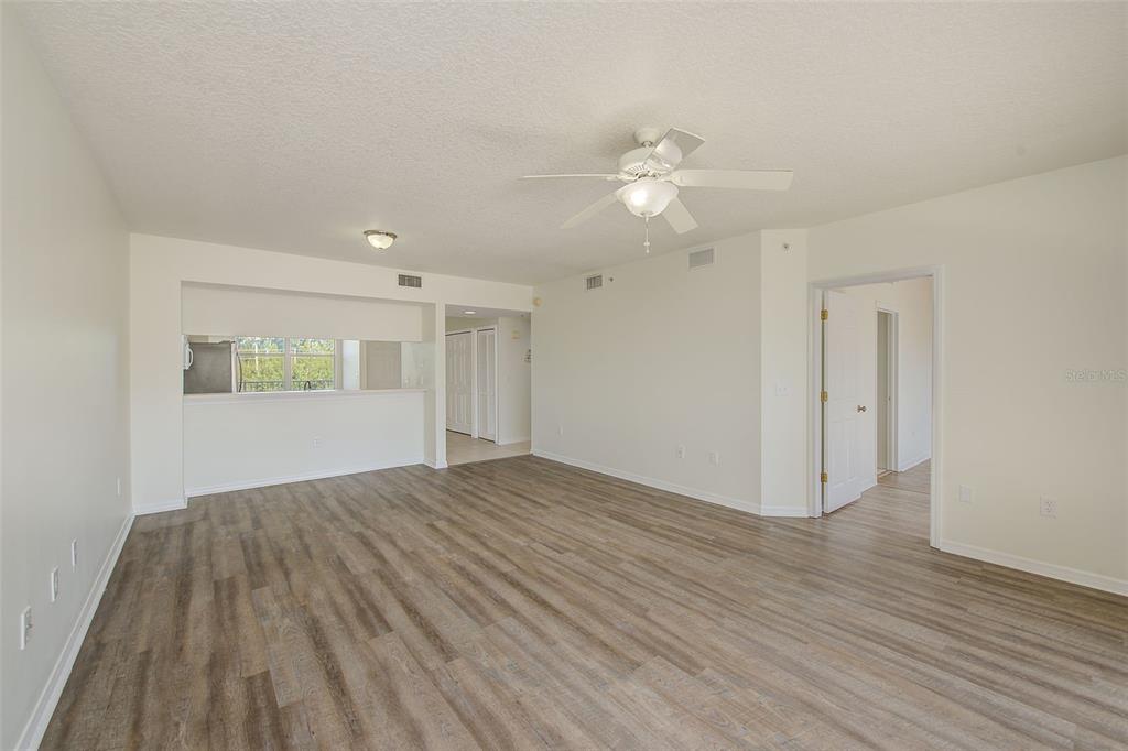 960 Starkey Road, Unit 3302 Largo, FL 33771 - Photo 9 of 28 wooden floor in an empty room with a window