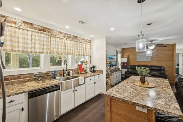 a kitchen with sink stove and cabinets