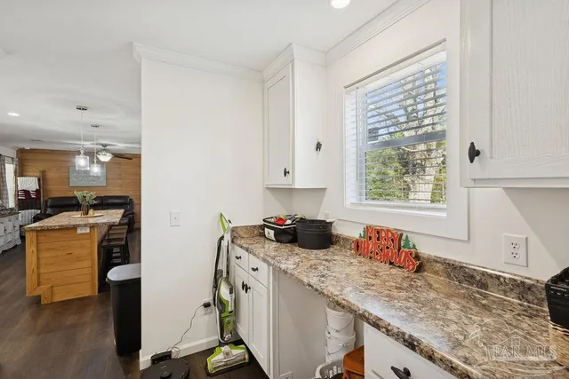 a kitchen with a stove a sink and a refrigerator