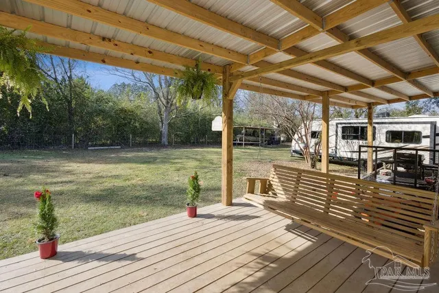 a view of a swimming pool with wooden deck