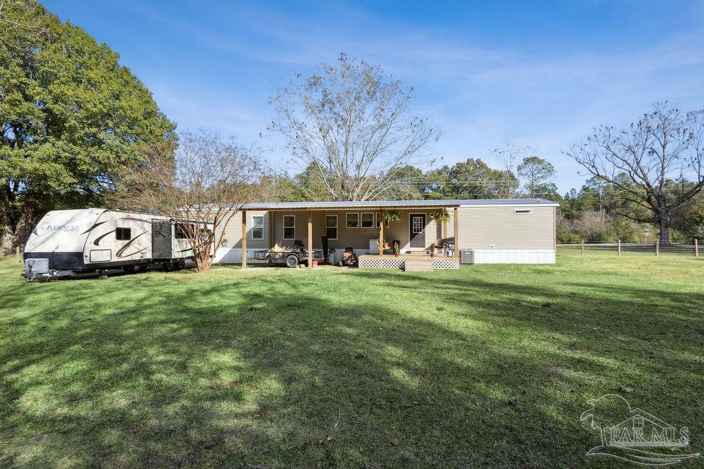 10309 Highway 89 Jay, FL 32565 - Photo 20 of 28 a front view of a house with garden