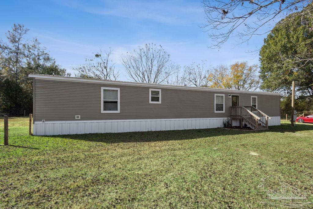 10309 Highway 89 Jay, FL 32565 - Photo 26 of 28 a view of a backyard with potted plants and large tree