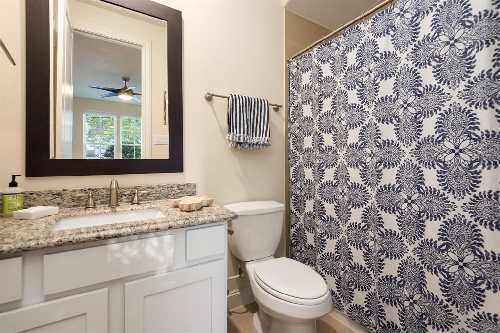 2010 Beall Street Houston, TX 77008 - Photo 4 of 17 a bathroom with a granite countertop sink mirror vanity and toilet