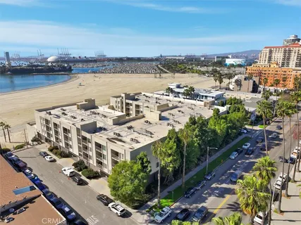 an aerial view of a building with streets and trees