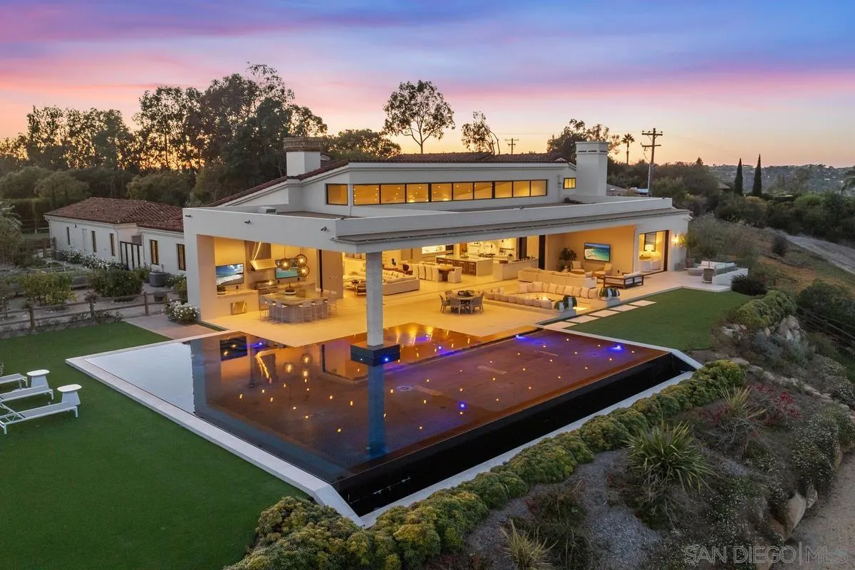 5516 La Crescenta Road Rancho Santa Fe, CA 92067 - Photo 42 of 49 a view of a big yard with table and chairs under an umbrella
