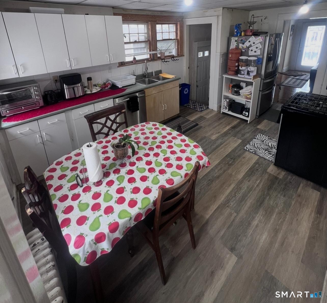 3461 East Main Street Bridgeport, CT 06606 - Photo 13 of 68 a kitchen with stainless steel appliances kitchen island granite countertop a sink dishwasher and a stove with wooden floor