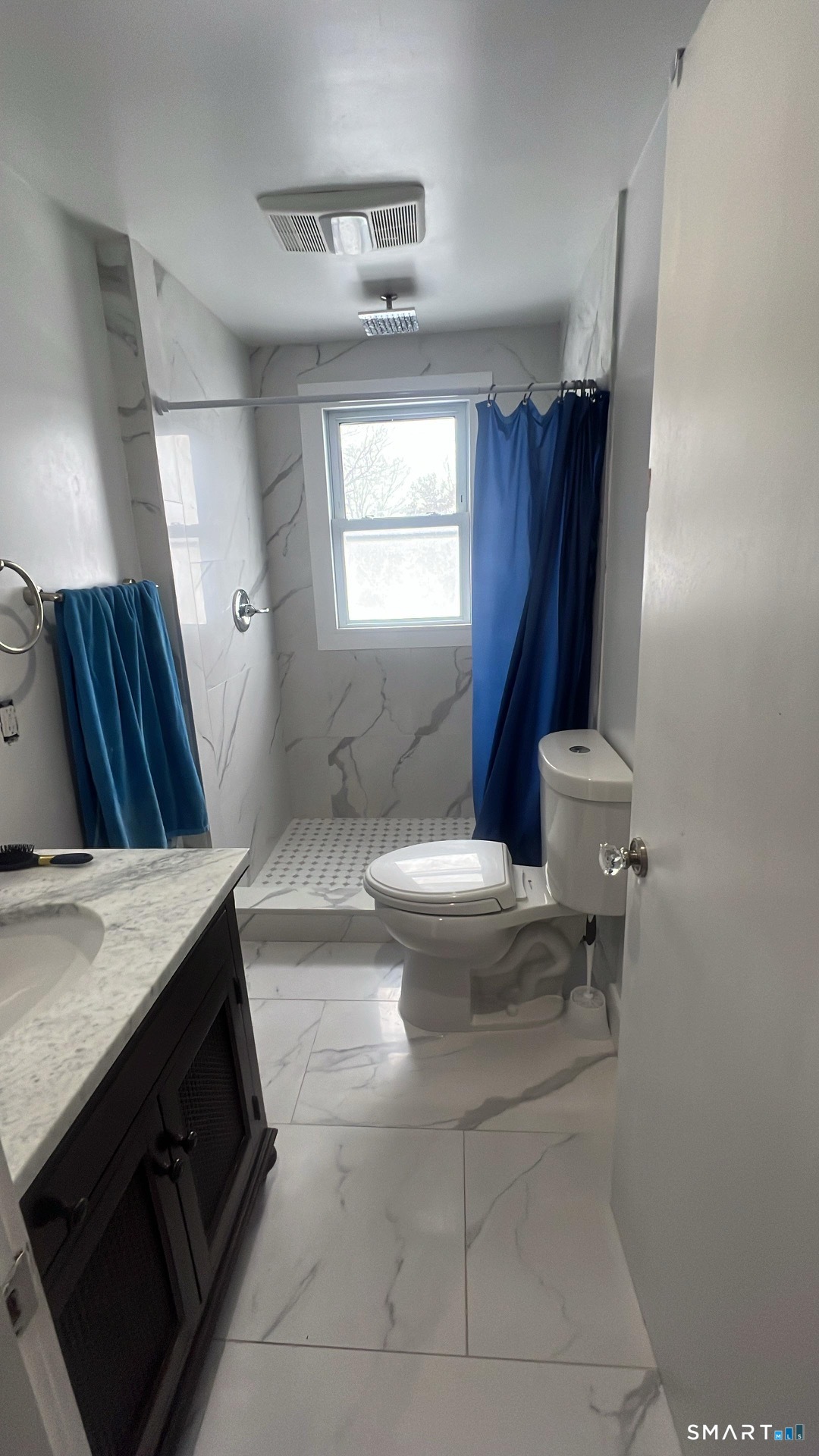 3461 East Main Street Bridgeport, CT 06606 - Photo 15 of 68 a bathroom with a granite countertop sink a toilet a mirror and bathtub
