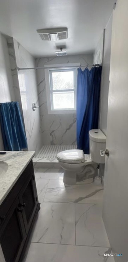 3461 East Main Street Bridgeport, CT 06606 - Photo 21 of 68 a bathroom with a sink a toilet a window and vanity