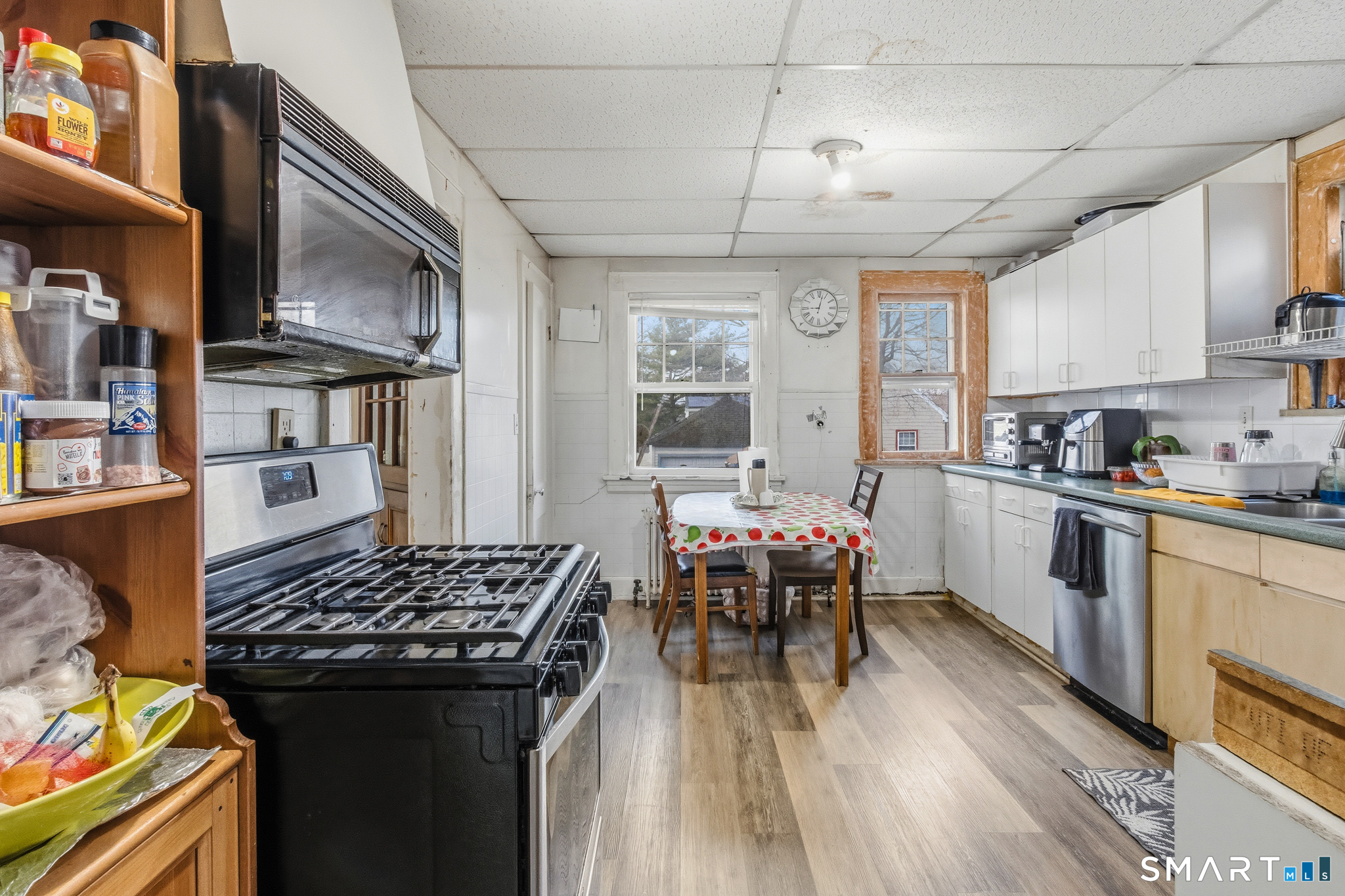 3461 East Main Street Bridgeport, CT 06606 - Photo 30 of 68 a kitchen with a table chairs stove and cabinets