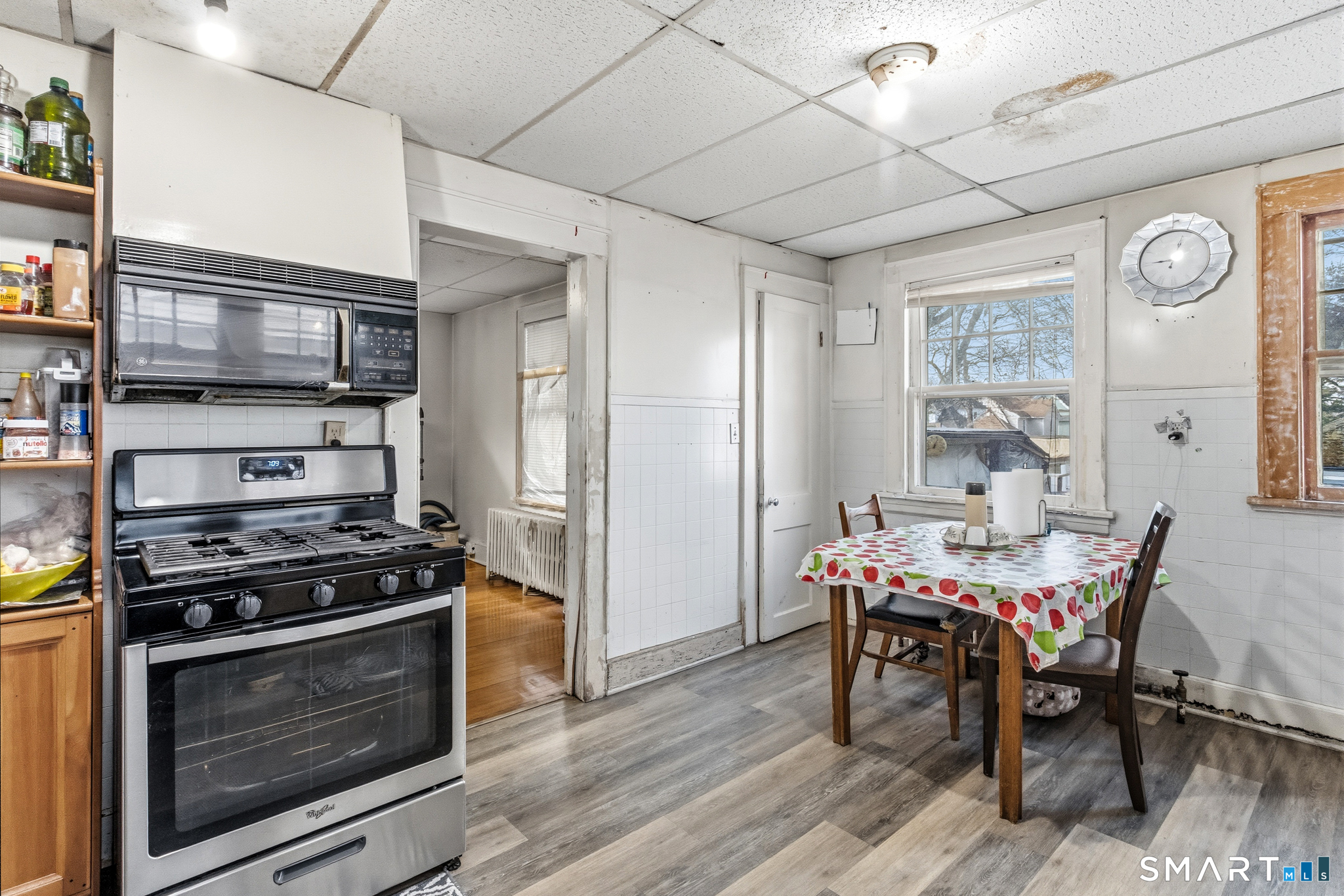 3461 East Main Street Bridgeport, CT 06606 - Photo 32 of 68 a kitchen with stainless steel appliances a stove a table and chairs