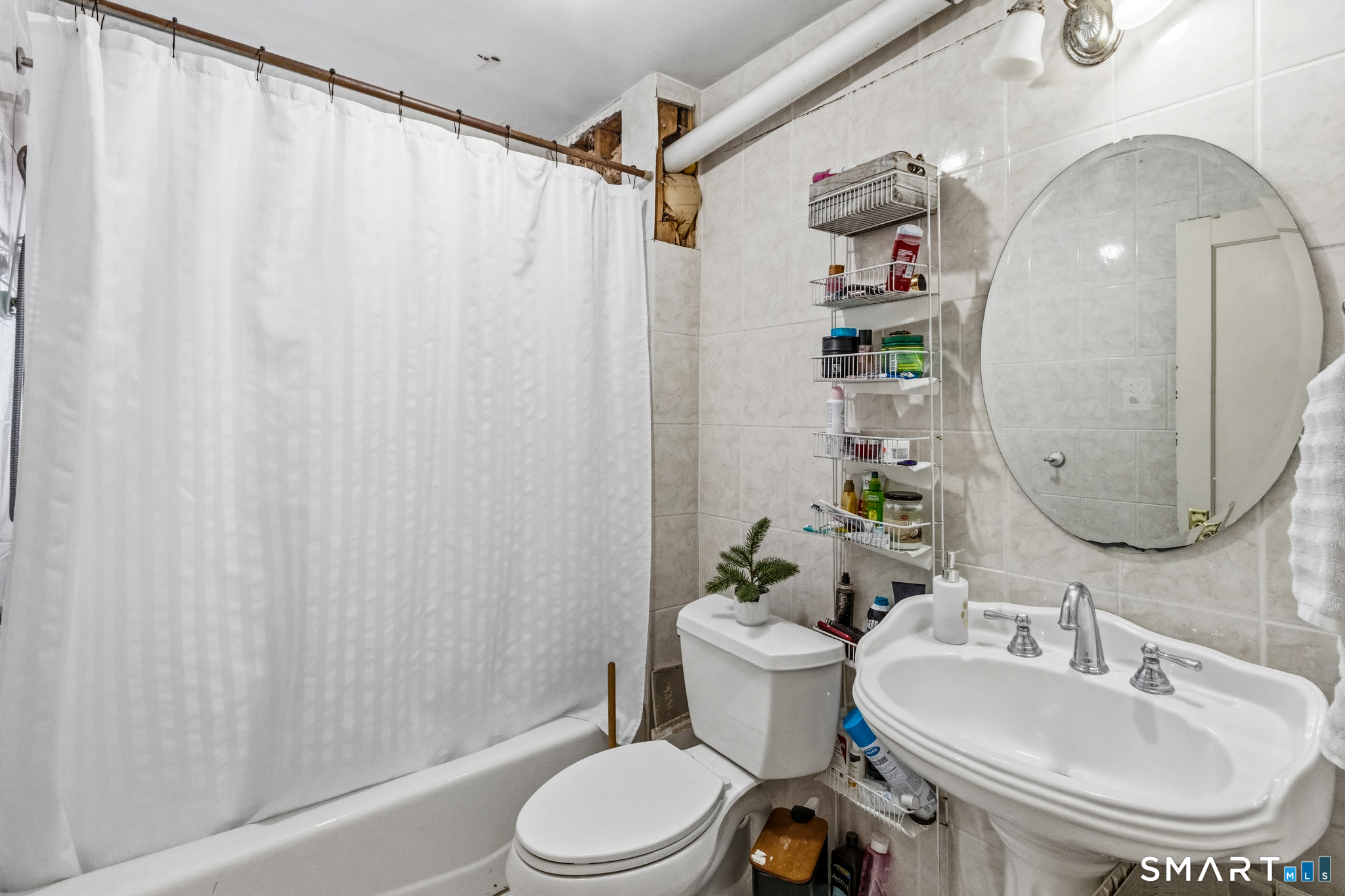 3461 East Main Street Bridgeport, CT 06606 - Photo 40 of 68 a bathroom with a sink toilet and shower
