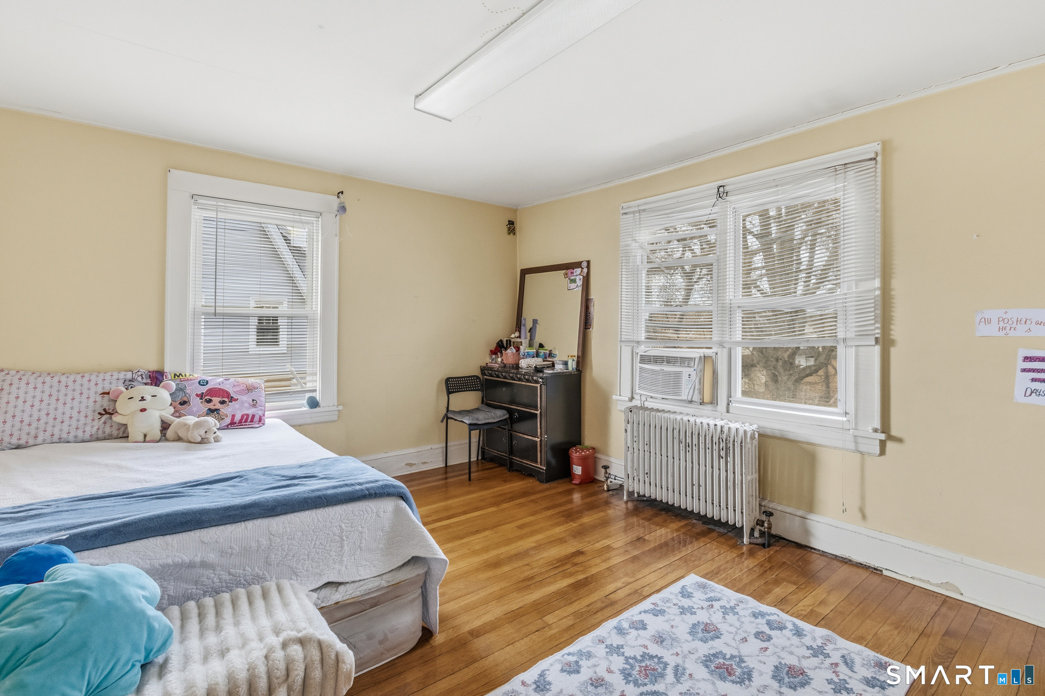 3461 East Main Street Bridgeport, CT 06606 - Photo 50 of 68 a bedroom with a bed and wooden floor