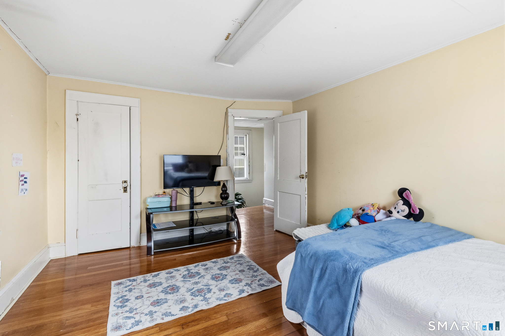 3461 East Main Street Bridgeport, CT 06606 - Photo 54 of 68 a bedroom with a bed and wooden floor