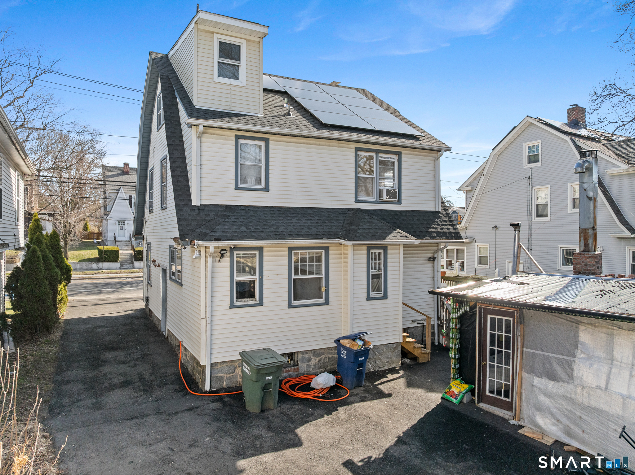 3461 East Main Street Bridgeport, CT 06606 - Photo 63 of 68 a view of a white house with many windows and table chairs