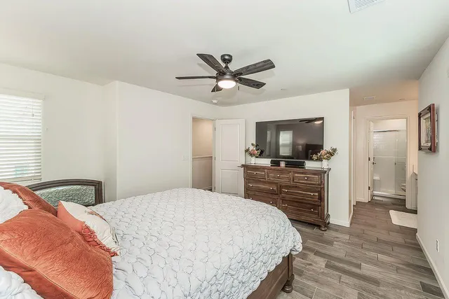 a bedroom with a bed and a flat screen tv