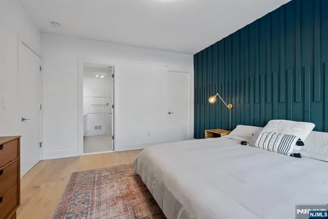 a kitchen with granite countertop a stove a sink and a dining table with wooden floor