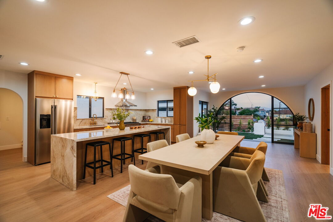 a view of a dining area with furniture wooden floor and chandelier